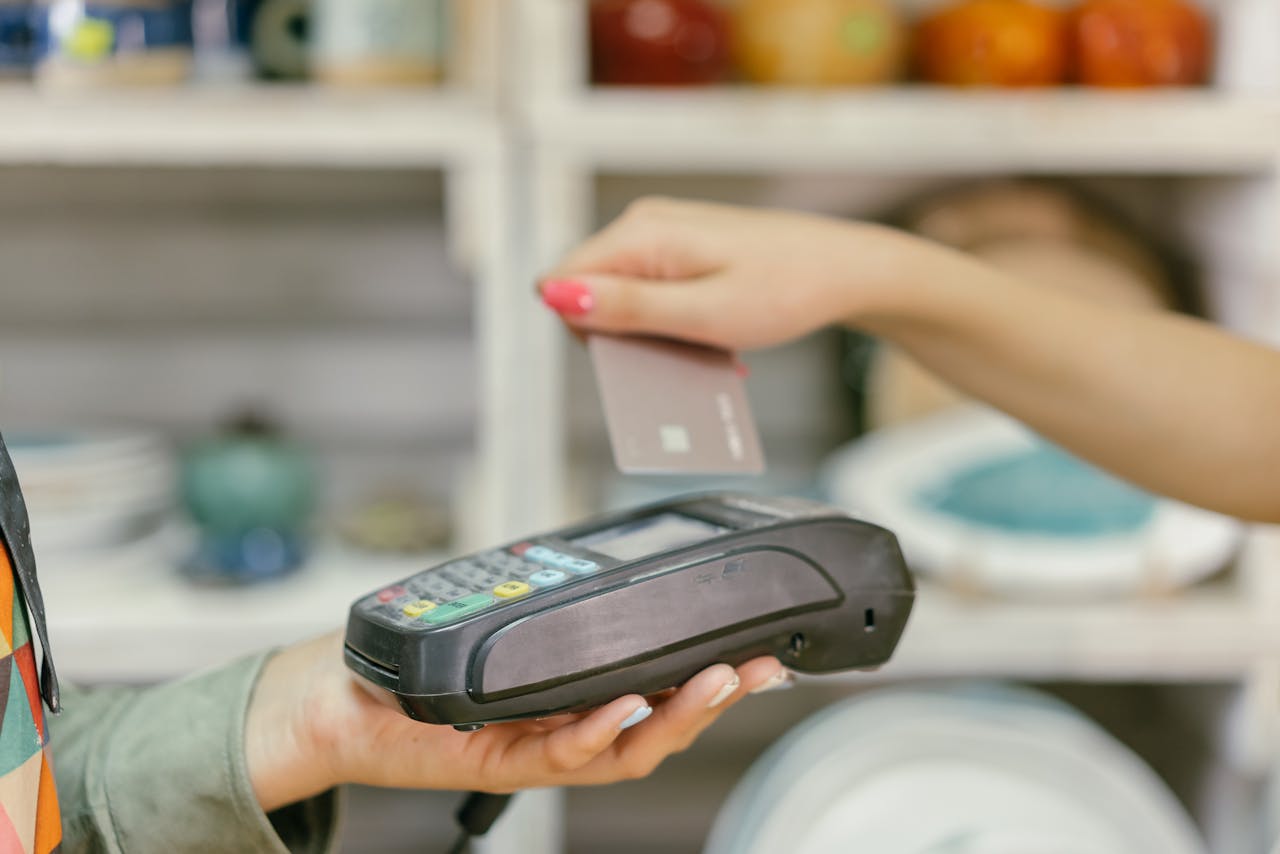 A Person Holding a Payment Terminal